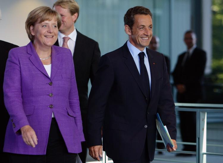 French President Nicolas Sarkozy and German Chancellor Angela Merkel arrive for a news conference at the Chancellery on August 31, 2009 in Berlin, Germany.  (Andreas Rentz/Getty Images)