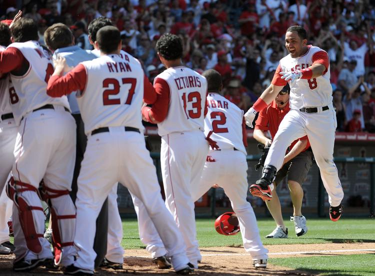 BE CAREFUL: Kendry Morales (right) landed awkwardly in his game-winning home run celebration, breaking his leg. (Harry How/Getty Images)