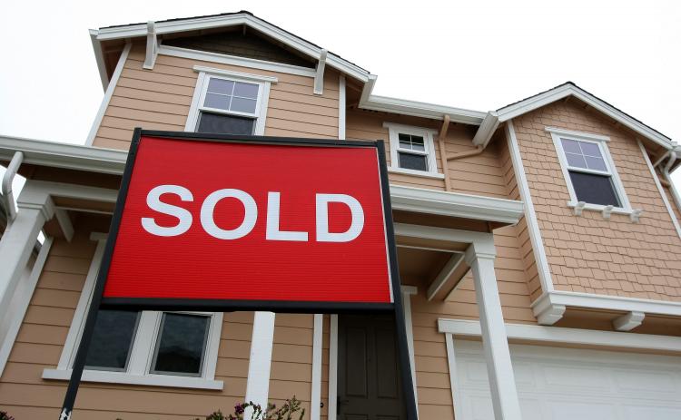 A sold sign is posted in front of a home in a new housing development May 4, 2009 in South San Francisco, California. (Justin Sullivan/Getty Images)