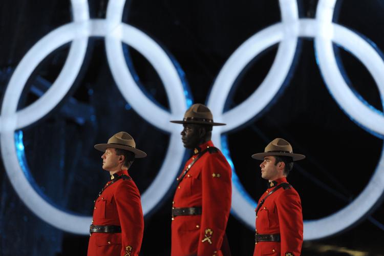 Mounties stand next to Olympic rings during the closing ceremony of the 2010 Winter Games in Vancouver. Violations of free expression during the Olympics was one of the topics covered in a new report by Canadian Journalists for Free Expression. (Dimitar Dilkoff/AFP/Getty Images)