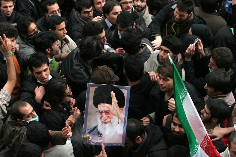 Iranian supporters (L) of defeated presidential candidate Mir Hossein Mousavi clash with supporters (R) of supreme leader Ayatollah Ali Khamenei (picture) at Tehran University in the Iranian capital on December 7, 2009. (-/AFP/Getty Images)