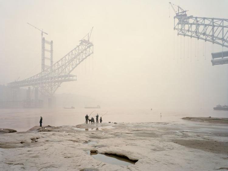 An image in Nadav Kander's book 'Yangtze-The Long River,' of the Chaotianmen Bridge, the world's longest arched bridge, being built over China's Yangtze river. (Courtesy of Hatje Cantz)