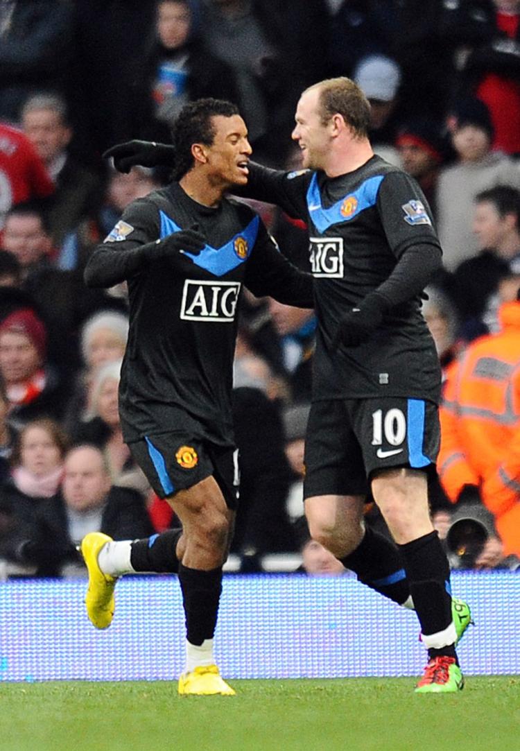 Nani (left) and Wayne Rooney ripped apart Arsenal in a 3-1 demolition on Sunday. (Carl de Souza/AFP/Getty Images)