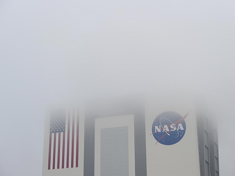 Fog surrounds the Vehicle Assembly Building April 19, 2010 at Kennedy Space Center in Florida just after NASA waved off the first landing attempt due to weather problems for the space shuttle Discovery. (Stan Honda/AFP/Getty Images)