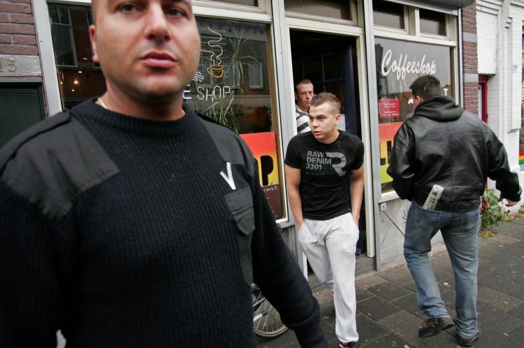 A bouncer (L) stands outside a coffee shop in Rosendaal, Netherlands on November 19, 2008. (Anoek de Groot/AFP/Getty Images)