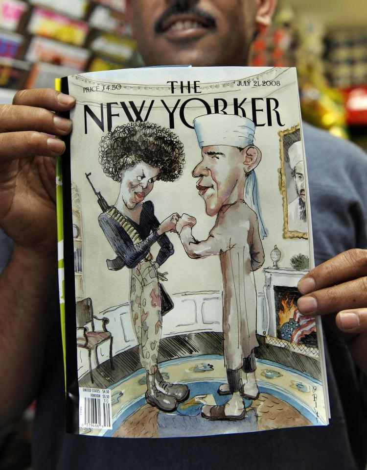 PRESIDENT OBAMA? Taleb Alkardai holds up a copy of the New Yorker magazine cover showing Democratic presidential candidate Barack Obama dressed as a Muslim and his wife as a terrorist at his midtown newsstand on Monday.(Timothy A. Clary/AFP/Getty Images)