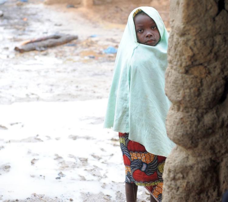 A Nigerian girl stands outside a dismantled makeshift structure where gold was processed by miners, leading to lead poisoning in Yargalm village, Bukkuyum Province, in Nigeria's northwest Zamfara State.  (Pius Utomi Ekpei/AFP/Getty Images)