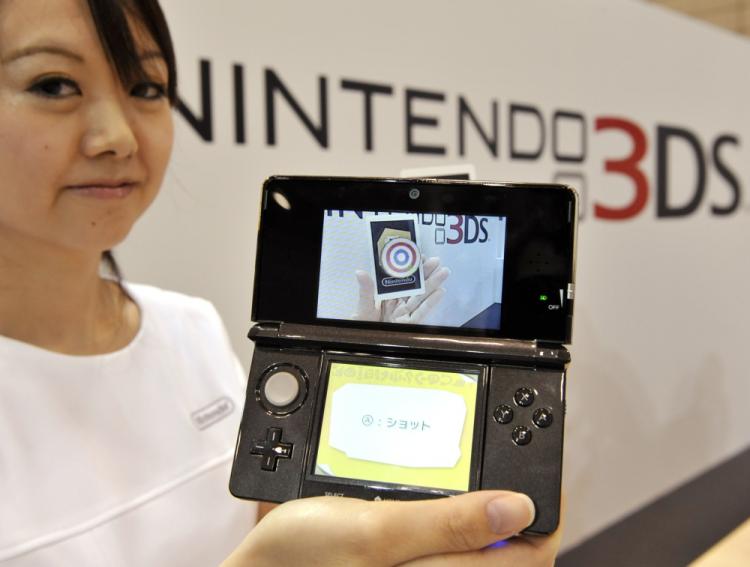 Nintendo 3D Games: A Nintendo employee displays a new portable videogame console with a 3D display called the 'Nintendo 3DS' at a conference in Chiba, suburban Tokyo on September 29, 2010. (Yoshikazu Tsuno/AFP/Getty Images)