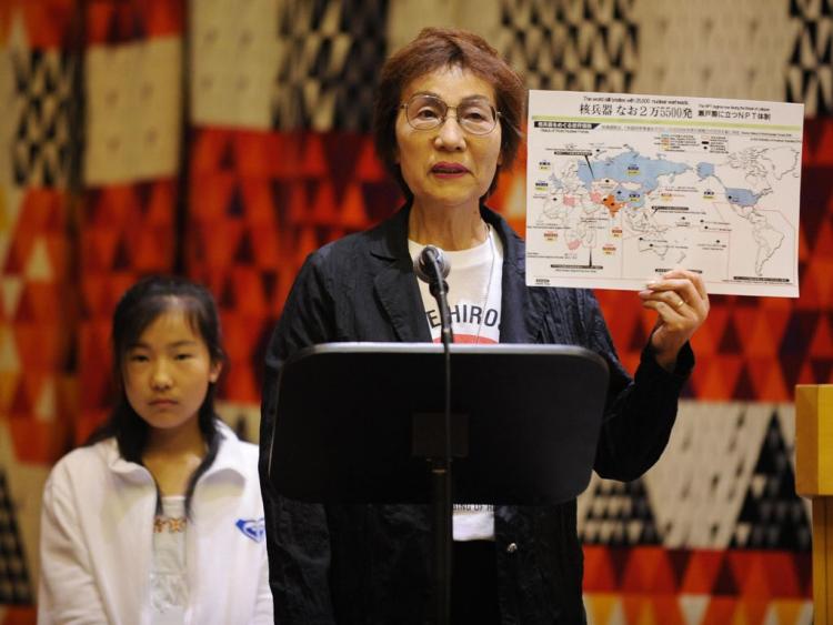 Emiko Okada, a survivor of the Hiroshima atomic bomb, holds a map showing countries with nuclear weapons during a meeting on nuclear disarmament organized by the Mayors for Peace at U.N. headquarters in New York in May. (Stan Honda/AFP/Getty Images)