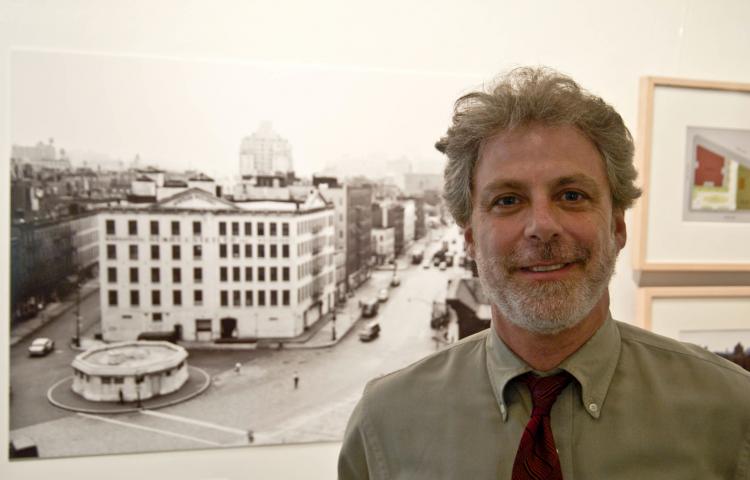 BEFORE THEY WERE PARKS: Curator Jonathan Kuhn stands next to a photo of the Stetler Warehouse, now the site of the Bleeker Street Playground.  (June Kellum/Epoch Times Staff )