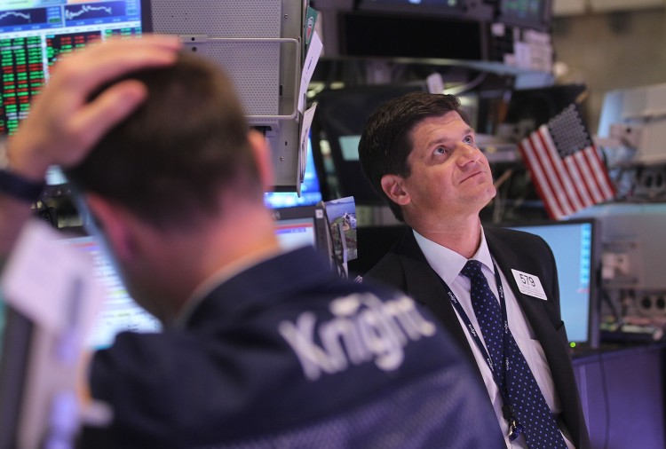 REBOUND: Traders look on at the New York Stock Exchange moments after the Federal Reserve made its policy announcement on August 9 in New York City. The Fed announced it would keep interest rates low through at least 2013.  (Mario Tama/Getty Images)