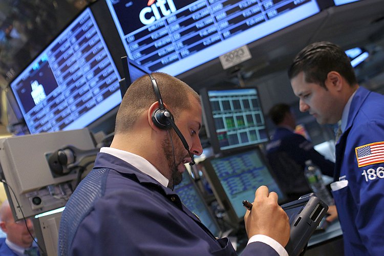 Traders work on the floor of the New York Stock Exchange