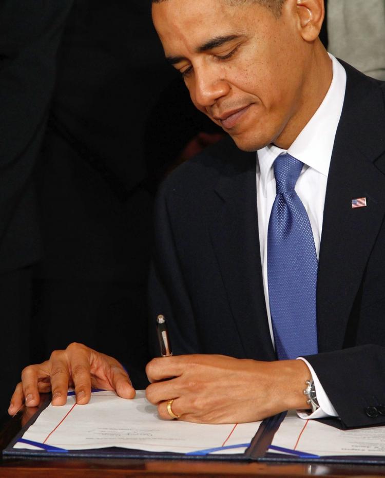 Barack Obama signs the Affordable Health Care for America Act during a ceremony with fellow Democrats in the East Room of the White House March 23 in Washington, D.C. Republicans maintain a clear position of repealing it. (Chip Somodevilla/Getty Images)