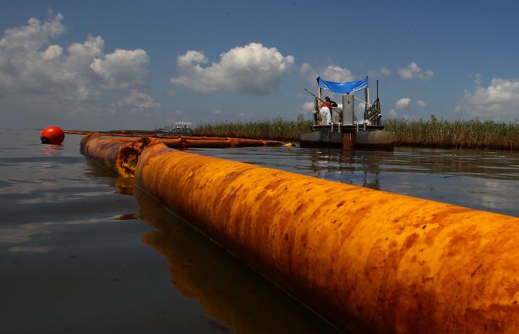 A boom floats in the water as contract workers from BP use skimmers to clean oil from a marsh on June 1. 'Flotels' have been set up to provide housing for workers who are helping with the clean up. (Win McNamee/Getty Images)