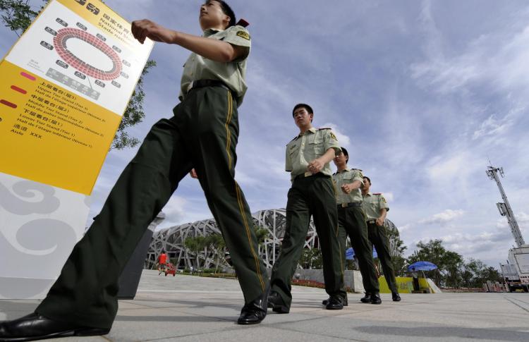 Chinese security personnel patrol the Olympics ground on Aug. 1, 2008, in preparation for the Beijing Olympics. Free speech activists and other citizens detained in connection with the Beijing Olympics are still being held six months after the games. (Jewel Samad/AFP/Getty Image)