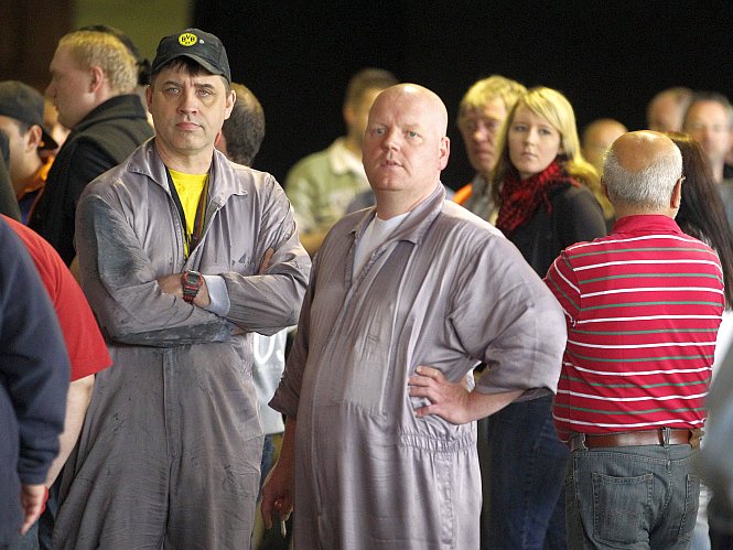 Employees of the car company Opel gather after a meeting at the Opel plant in Bochum, Germany, May 21. Opel is planning to cut working hours of its German workforce in half starting in September.