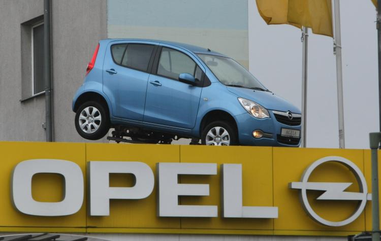A car stands on top of the logo of German automaker Opel at a dealership in Berlin, Germany. Opel, a subsidiary of troubled parent GM, faces an uncertain future. (Sean Gallup/Getty Images)