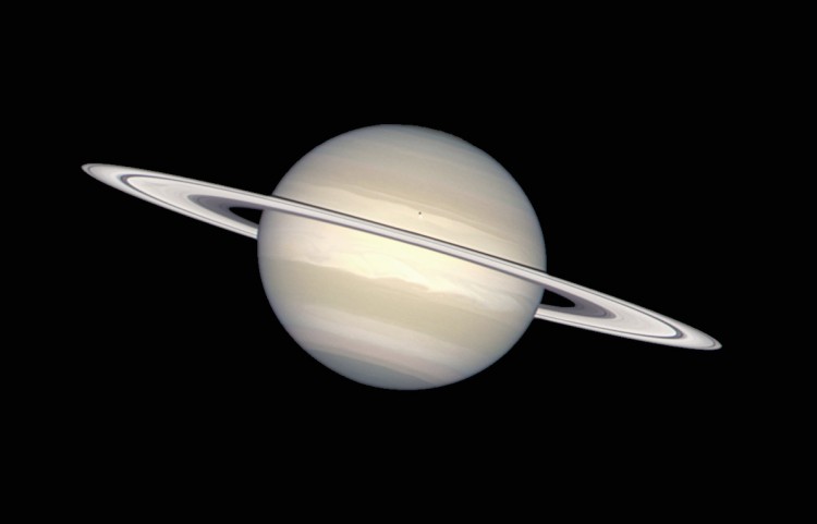 Saturn In Natural Colors, as taken by the Hubble Space Telescope. The ring swirling around Saturn consists of chunks of ice and dust. Saturn itself is made of ammonia ice and methane gas. The little dark spot on Saturn is the shadow from Saturn's moon Enceladus. (Hubble Heritage Team (AURA/STScI/NASA/ESA))