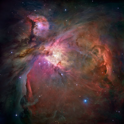 Overview image of the Orion Nebula with the star cluster at its center. The possible black hole would reside somewhere between the four bright stars which mark the cluster's center. These stars form the famous Trapezium of the Orion Nebula Cluster. (NASA/ESA/Hubble Space Telescope) 