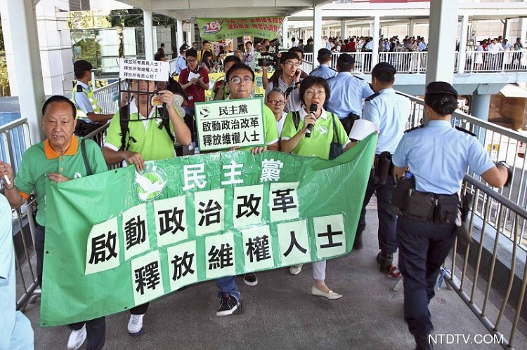 Demonstrating against the communist regime's tyranny, protesters are met by a police blockade in Hong Kong. (Courtesy of NTD Television)