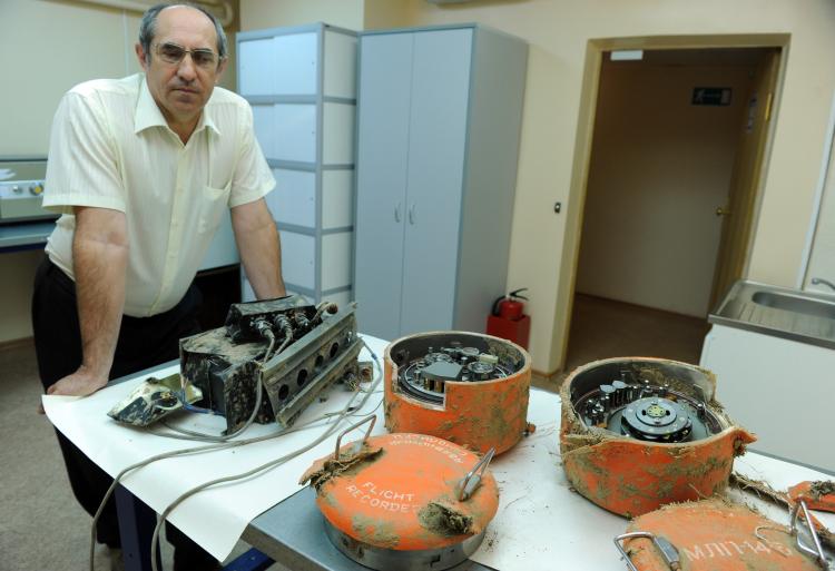 A Russian expert from the inter-state air committee stands near the flight recorders from the plane of Polish President Lech Kaczynski in Moscow on May 19. Non-crew members were in the cockpit of the plane of Polish president Lech Kaczynski before its fat (Natalia Kolesnikova/AFP/Getty Images)