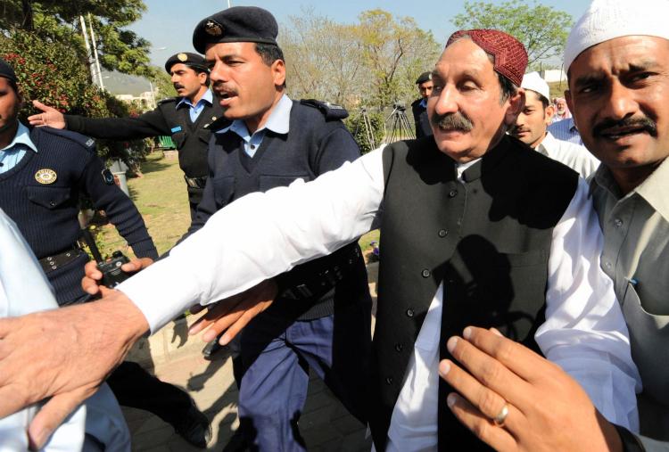 Deposed Pakistani chief justice Iftikhar (center) was reinstated on Sunday after nationwide protests. (Aamir Qureshi/AFP/Getty Images)