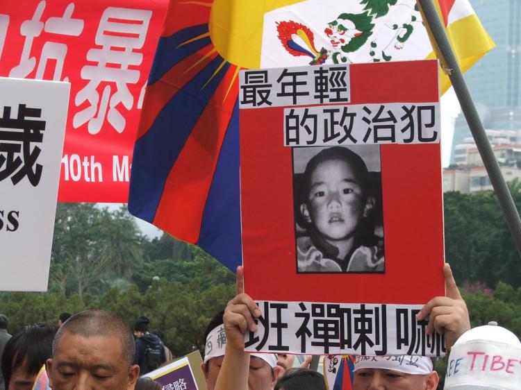 Tibetan activists hold a portrait of Gendun Choekyi Nyima, the young boy who was selected by the Dalai Lama as the 11th Panchen Lama. (David Reid)