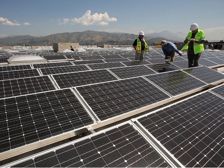 Solar panels cover the roof of a Sam's Club store in April 2009 in Glendora, California. Solar panel installers will be trained as part of a $100 million package to give green jobs a lift in the U.S. Other training areas include hybrid/electric auto technicians, weatherization specialists, and wind and energy auditors. (David McNew/Getty Images)