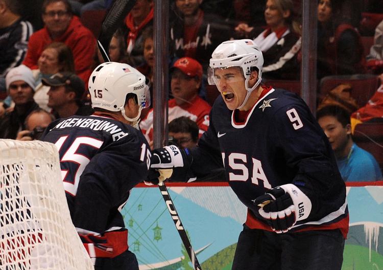 AMERICAN DEVILS: Zach Parise (right) celebrates with his captain Jamie Langenbrunner after scoring against the Swiss on Wednesday. (Luis Acosta/AFP/Getty Images)