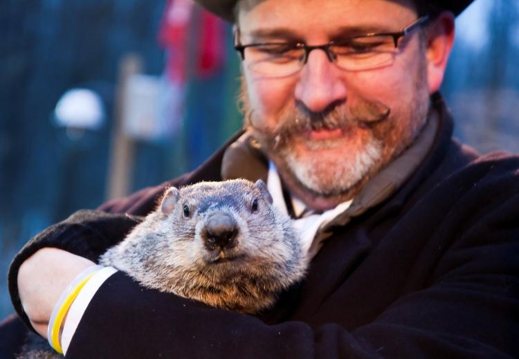 Punxsutawney Phil Poses: One of Phil's main handlers, Ben Hughes, protects the prognosticating rodent from the crowds, folloing his emergence at Gobbler's Knob on Feb. 2, 2010. (Jan Jekielek/The Epoch Times)