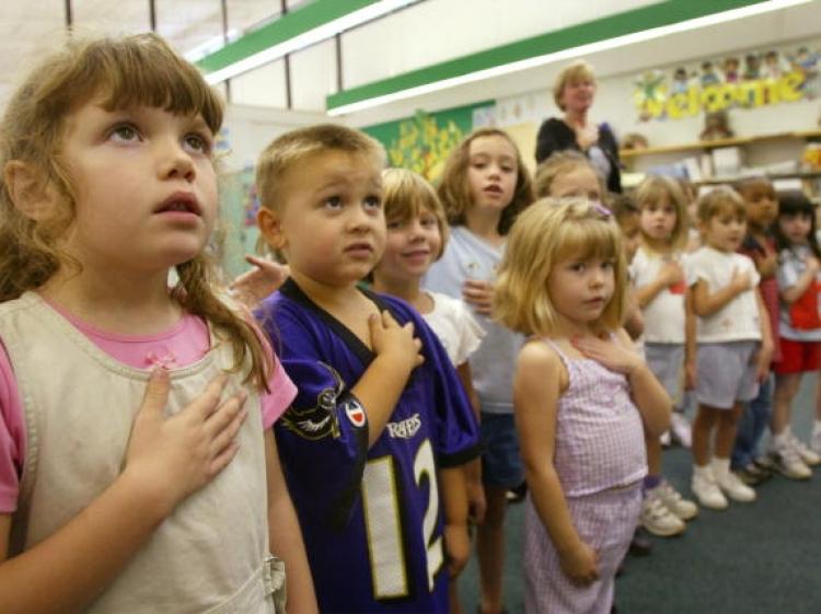 TAKING OATH: Children recite the Pledge of Allegiance in a classroom in Maryland. The pledge,often taught in schools across America, is an optional pledge according to the First Amendment. (Mark Wilson/Getty Images)