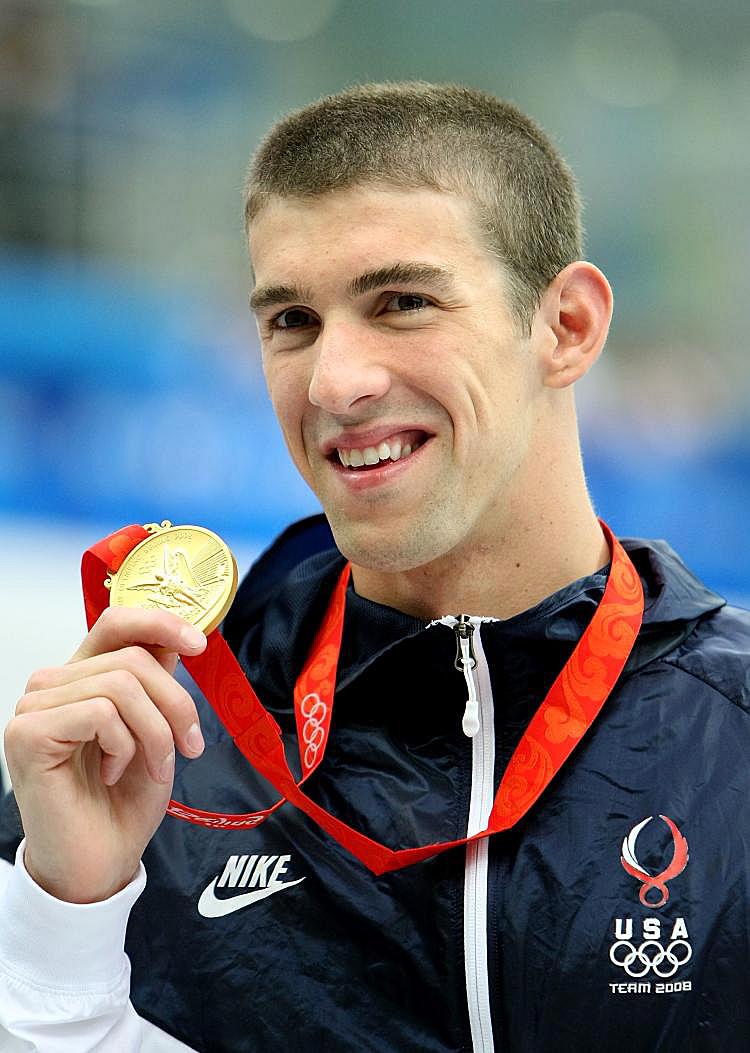 American Michael Phelps, on his way to becoming the greatest Olympian of all time, poses with his gold medal after winning the Men's 200m Freestyle. (Jed Jacobsohn/Getty Images)