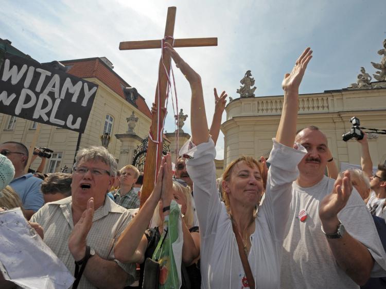 Protesters demonstrate in front of the presidential palace in Warsaw on Aug. 3. Authorities failed to move a wooden cross commemorating Poland's late leader Lech Kaczynski from in front of the presidential palace after fierce protests by Roman Catholic gr (Janek Skarzynski/AFP/Getty Images)