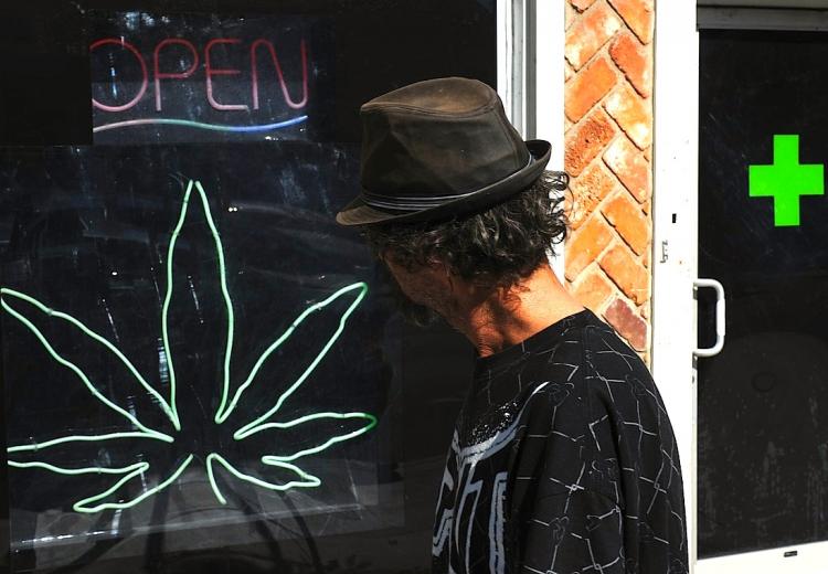 GOING TO POT: A man walks past a medicinal marijuana dispensary in Los Angeles, Calif. Marijuana use and availability is on the rise with Americans, according to survey data released by the Substance Abuse and Mental Health Services Administration (SAMHSA (Mark Ralston/Getty Images)