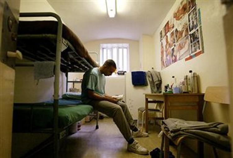 A prisoner reads a book in his cell at HMP (Her Majesty's Prison) Pentonville May 19, 2003 in London. (Ian Waldie/Getty Images)