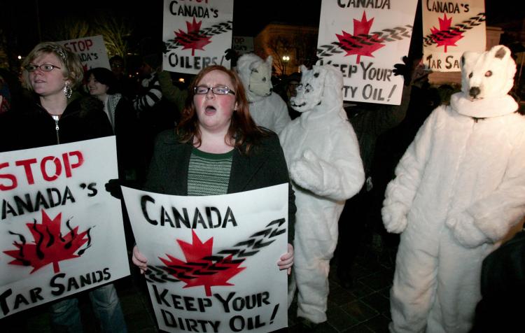 Environmental demonstrators from Oil Change International and ForestEthics protest a visit by Alberta Premier Ed Stelmach outside the Canadian Embassy in Washington in January 2008.  ((SAUL LOEB/AFP/Getty Images))