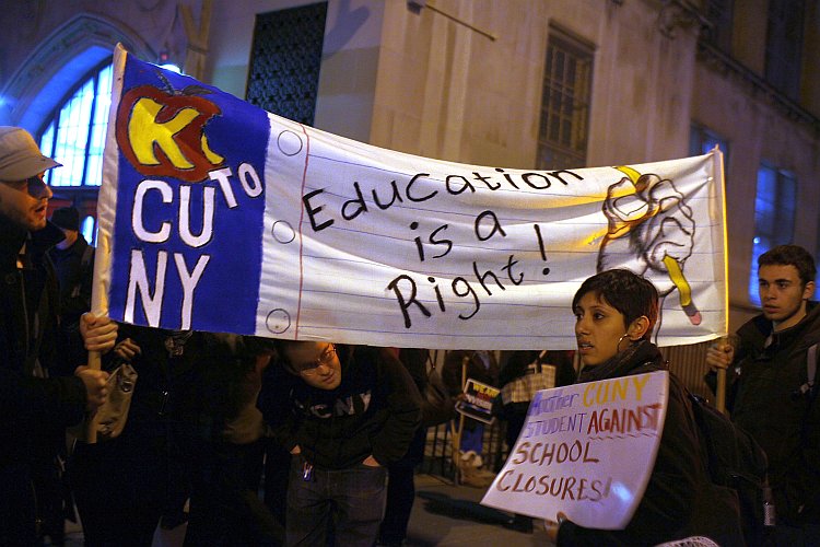 People protest outside during a Panel for Educational Policy