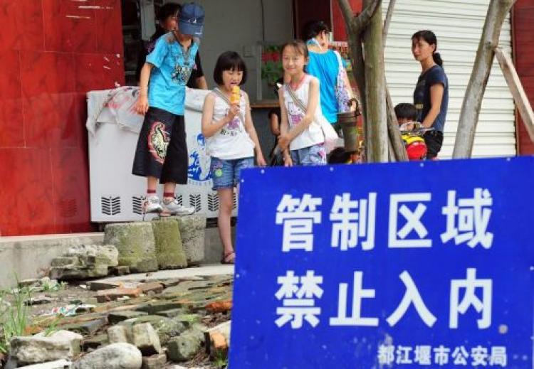 An access denied warning sign next to the collapsed Dujiangyan Middle School. Many question the quality of this school building after the Sichuan earthquake. (Frederic J. Brown/AFP/Getty Images)