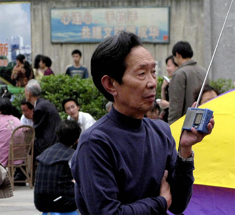 An elderly Chinese man listens to the news on his radio.  (AFP/Getty Images)