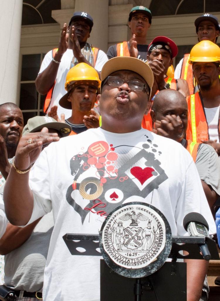 Darnel Canada, President of REBUILD, addresses unemployment issues, in front of City Hall on Thursday. (Cliff Jia/The Epoch Times)