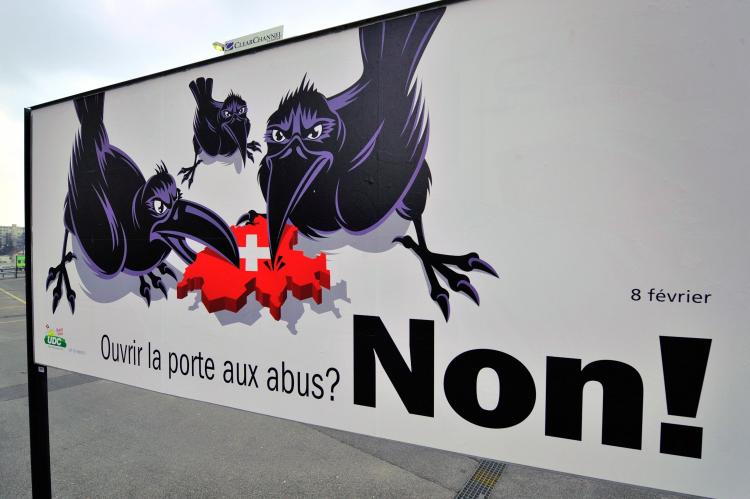 An election poster of the right-wing Swiss People's Party (SVP) showing three crows surrounding Switzerland and reading in French: 'Open doors for abuse? NO!' is seen in Chavannes near Lausanne, western of Switzerland on January 5, 2009. Despite deepening (Fabrice Coffrini/AFP/Getty Images)