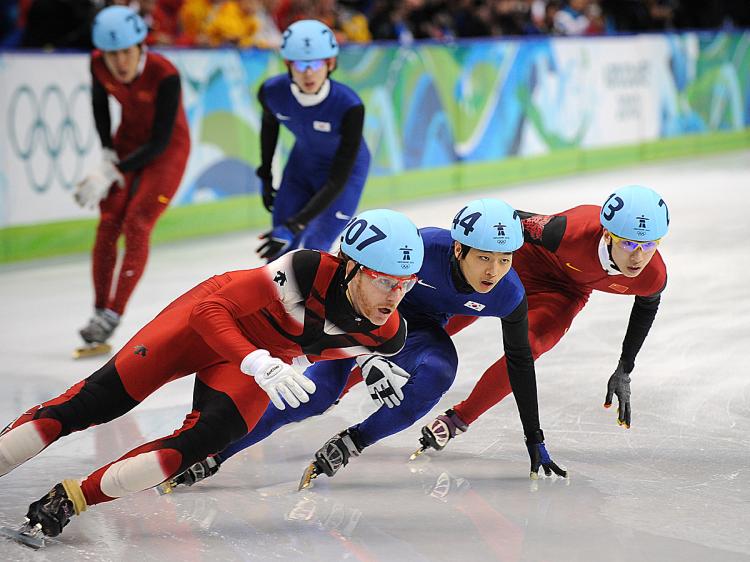(L-R) Canada's Francois-Louis Tremblay, South Korea's Si-Bak Sung and China's Weilong Song compete in the Men's 5000 m relay short-track final at the 2010 Winter Olympics. (Robyn Beck/AFP/Getty Images)