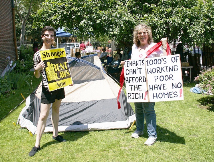 TOUTING REFORM: Mary Tek (L), Real Rent Reform Campaign Manager, and Karen Smith, retired State Supreme Court Justice, advocate for stronger rent laws during the tent city demonstration on May 31 at Church of the Holy Apostles in Manhattan.  (Ivan Pentchoukov/The Epoch Times)