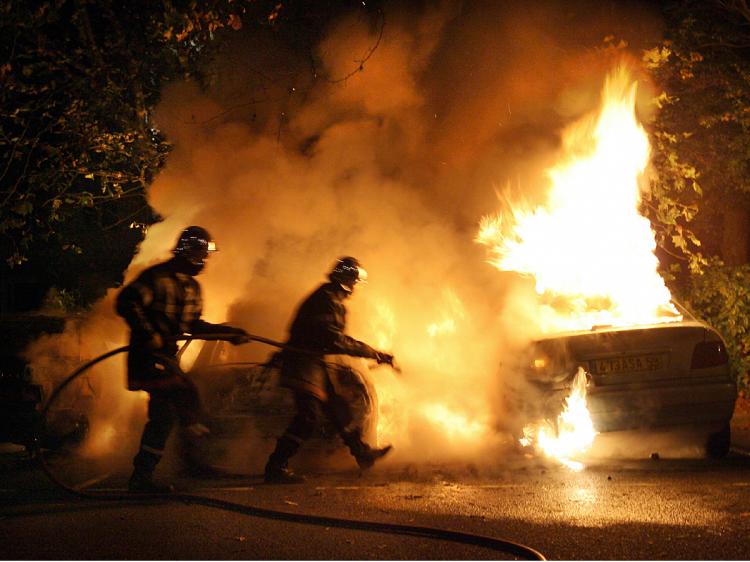 Firemen try to extinguish three cars set ablaze by rioting youth, in Loos near Lille northern France.    (Philippe Huguen/AFP/Getty Images)