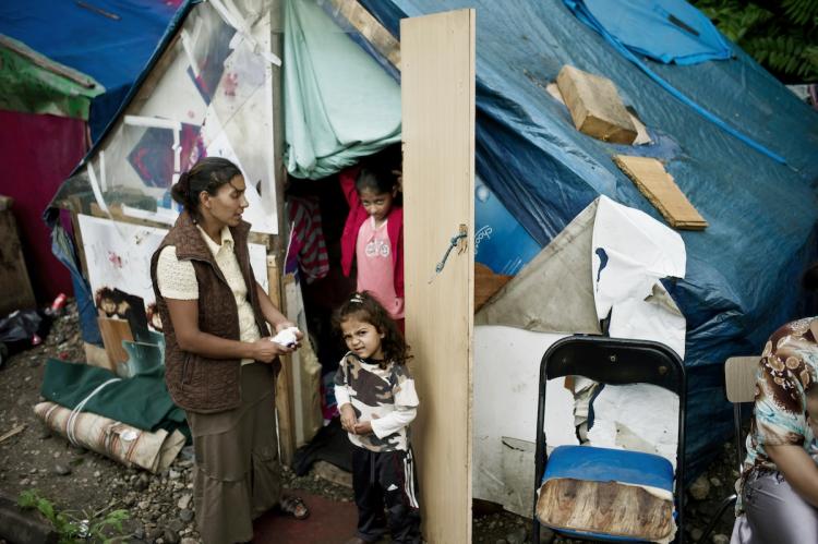 Women and children, who belong to the Roma community, stand near a shack on July 29 in a camp near the French eastern city of Lyon, as people who are living in the camp could be expelled. Violence between police and Gypsies prompted French President Nicolas Sarkozy to summon ministers for crisis talks on July 28, warning that the minority posed security 'problems.' (Jeff Pachoud/AFP/Getty Images)