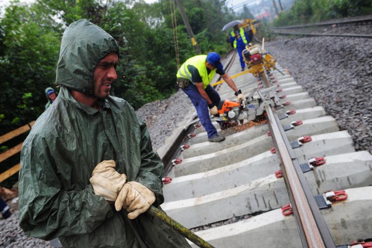 Romanian railway workers work at Sinaia working point on July 16. In Romania, the government's austerity program is slowing down the economy, as the government promised to cut public sector wages by 25 percent and increase VAT by 5 percent. (Daniel Mihailescu/Getty Images)
