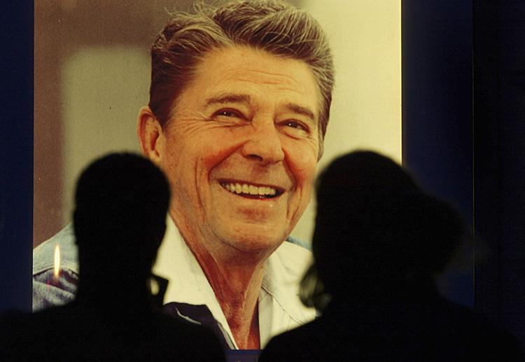 Ronald Reagan: People look at a portrait of former President Ronald Reagan in front of the Ronald Reagan building and International trade Centre in June 2004 in Washington DC. Ronald Reagan died at the age of 93 on June 5, 2004 after a ten year battle with Alzheimer's disease. (Paula Bronstein/Getty Images)