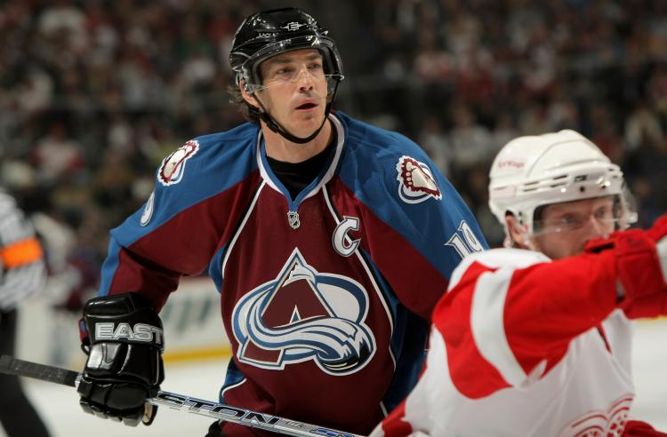 Joe Sakic, front left, waves to the crowd during ceremony to mark his  retirement from the Colorado Avalanche before the team's home opener of the  2009-2010 NHL season against the San Jose