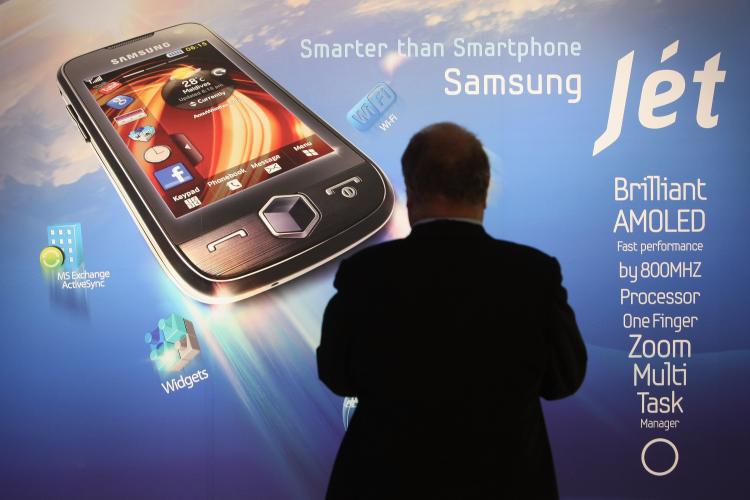 A visitor stops at a poster for Samsung's new Jet smartphone at the Samsung stand on opening day at the IFA technology trade fair on September 4, 2009 in Berlin, Germany. (Sean Gallup/Getty Images)