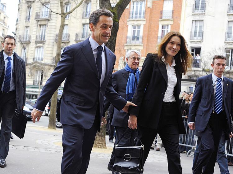 French President Nicolas Sarkozy (C) and first lady Carla Bruni-Sarkozy (Olivier Laban-Mattei/AFP/Getty Images)